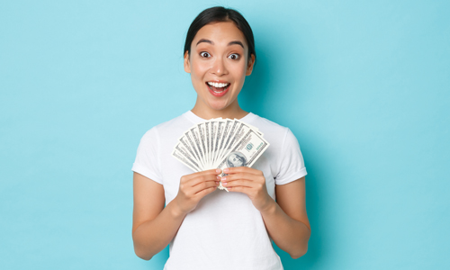 Happy woman holding hundred dollar bills, because of early direct deposit.
