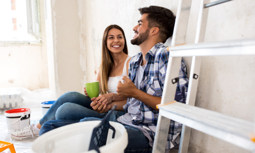 Man and woman sitting in their home during renovation.