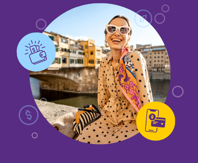 Happy woman wearing sunglasses and a polka dot dress sitting outside on vacation.